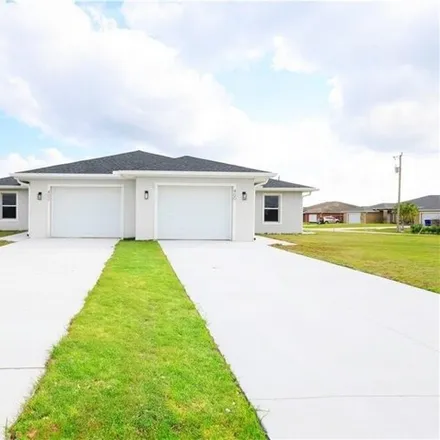 Rent this 3 bed house on 402 Grant Blvd in Lehigh Acres, Florida