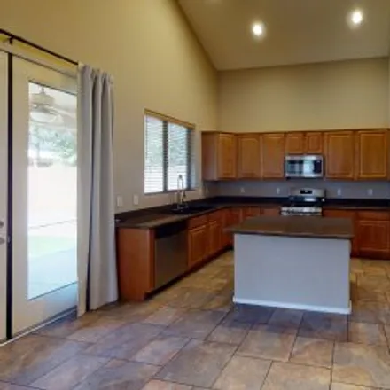 Rent this 4 bed apartment on 7036 South Bridal Vail Drive in Seville, Gilbert