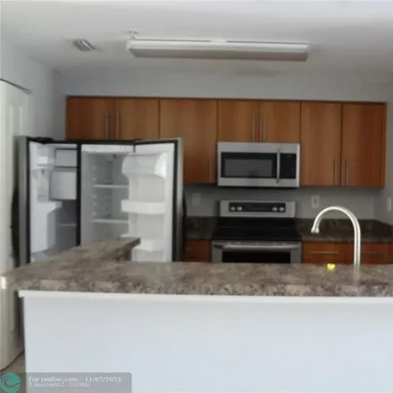 Rent this 3 bed condo on Garrett Academy in West Sample Road, Coral Springs