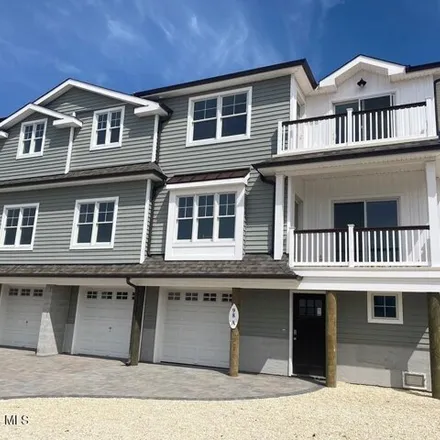 Rent this 4 bed townhouse on 98 Grand Central Ave Unit A in Lavallette, New Jersey