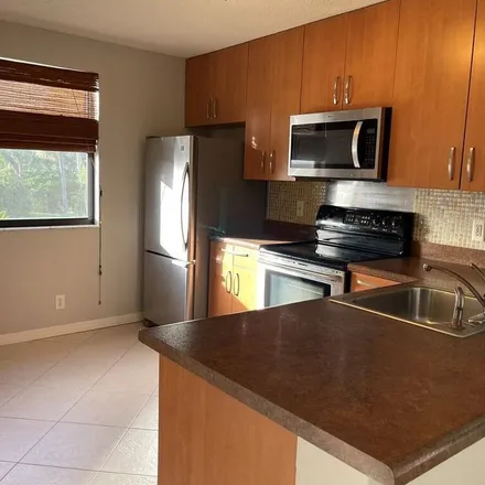 Rent this 2 bed apartment on 5725 Riverside Drive in Pine Ridge Villas, Coral Springs