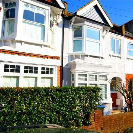 Rent this 4 bed townhouse on 25 Durnsford Avenue in London, SW19 8BH