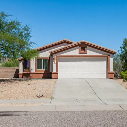 Buy this 4 bed house on 5870 West Aster Bloom Drive in Pima County, AZ 85735