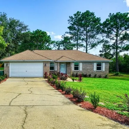Rent this 4 bed house on 8828 Arlington Ln in Navarre, Florida