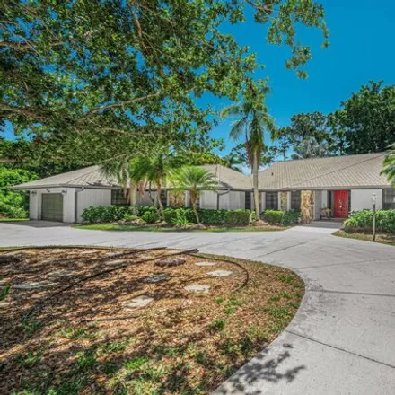 Buy this 4 bed house on 3612 Sw Mashie Ct in Palm City, Florida