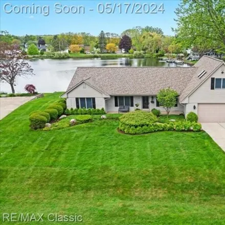 Buy this 4 bed house on 4977 Wavewood Drive in Commerce Charter Township, MI 48382