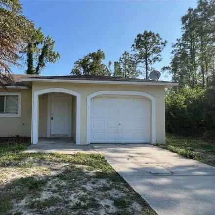 Rent this 2 bed house on 407 East 12th Street in Lehigh Acres, FL 33972