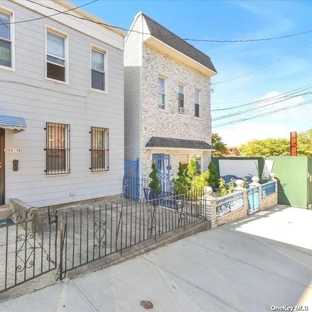 Buy this 6 bed townhouse on 52-14 83rd Street in New York, NY 11373