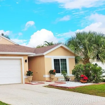 Buy this 4 bed house on 1717 Sawgrass Circle in Greenacres, FL 33413