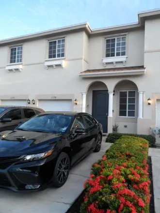 Buy this 4 bed townhouse on U-Haul in Northwest 27th Avenue, Carol City