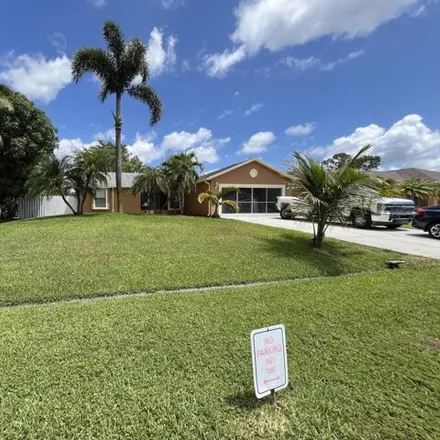 Buy this 3 bed house on 1673 Southwest Mullinax Avenue in Port Saint Lucie, FL 34953