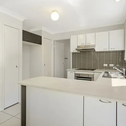 Rent this 3 bed townhouse on Pitcairn Way in Pacific Pines QLD 4210, Australia