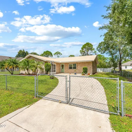 Buy this 3 bed house on 1663 Saipan Street Southeast in Palm Bay, FL 32909