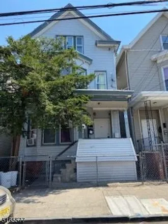 Buy this 6 bed townhouse on 711 East 18th Street in Paterson, NJ 07501