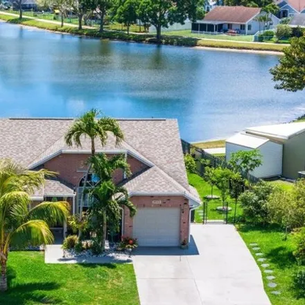 Buy this 3 bed house on 5569 Pebble Brook Lane in Rainbow Lakes, Palm Beach County