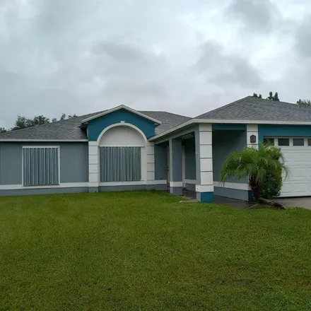 Rent this 4 bed house on 860 Adour Drive in Poinciana, FL 34759