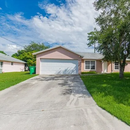 Rent this 3 bed house on 719 SE Atlantus Ave in Port Saint Lucie, Florida