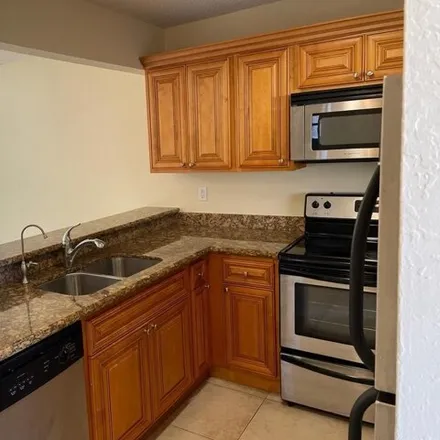 Rent this 2 bed condo on 1648 Windorah Way in Golden Lakes, Palm Beach County