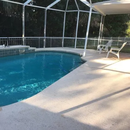 Rent this 3 bed house on 7798 Southeast Needle Palm Circle in Martin County, FL 33455