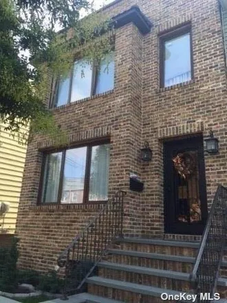 Buy this 5 bed townhouse on 59-14 74th Street in New York, NY 11378