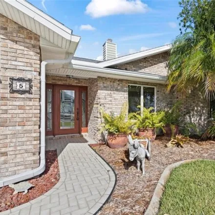 Buy this 3 bed house on 5 Crazy Horse Ct in Palm Coast, Florida