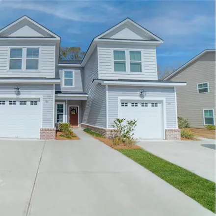 Rent this 3 bed townhouse on 53 Ainsdale Drive in Richmond Hill, GA 31324