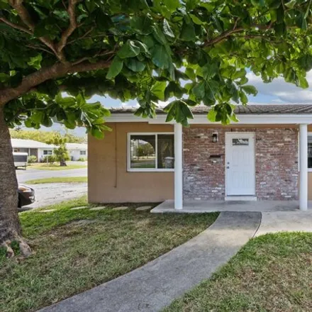 Rent this 2 bed house on 2553 Northeast 10th Court in Pinehurst Village, Pompano Beach