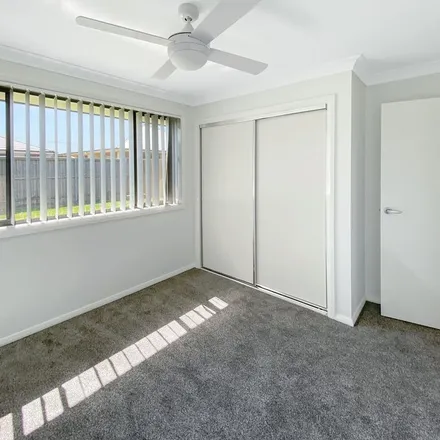 Rent this 4 bed apartment on 48 Arrowtail Street in Chisholm NSW 2322, Australia