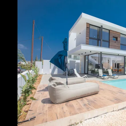 Rent this 4 bed house on Fig tree Bay Villa 4 in Dionysou, 5297 Protaras