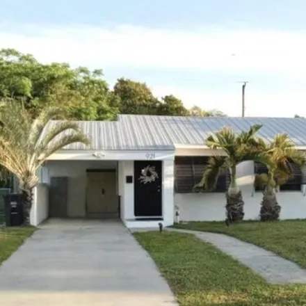 Buy this 3 bed house on 921 Macy St in West Palm Beach, Florida