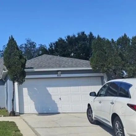 Rent this 4 bed house on 421 Martigues Drive in Poinciana, FL 34759