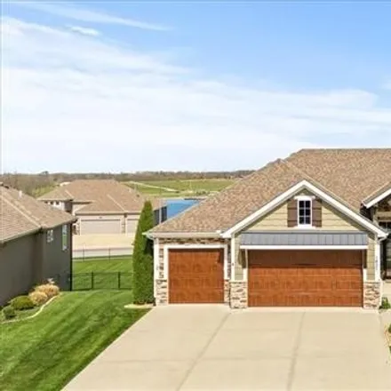Buy this 4 bed house on 1413 Kensington Lane in Raymore, MO 64083