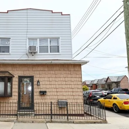 Buy this 5 bed house on 59-19 69th Street in New York, NY 11378