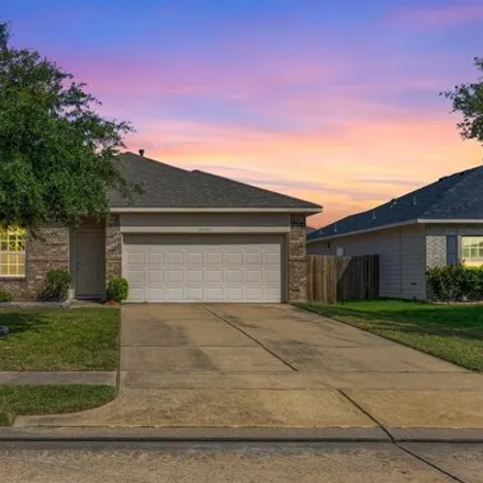 Rent this 4 bed house on 10917 Woodwind Shadows Drive in Towne Lake, TX 77433