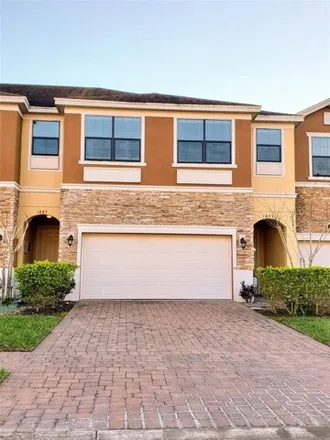Rent this 4 bed townhouse on 1903 Portofino Meadows Boulevard in Meadow Woods, Orange County