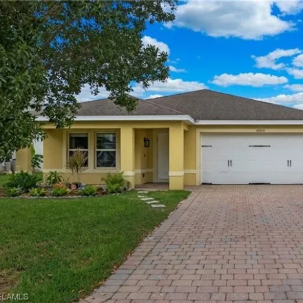Rent this 4 bed house on 10424 Canal Brook Lane in Lehigh Acres, FL 33936