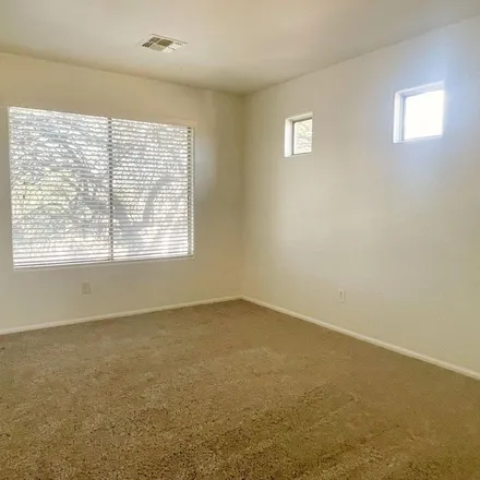 Rent this 4 bed apartment on 715 East Beargrass Place in San Tan Valley, AZ 85143