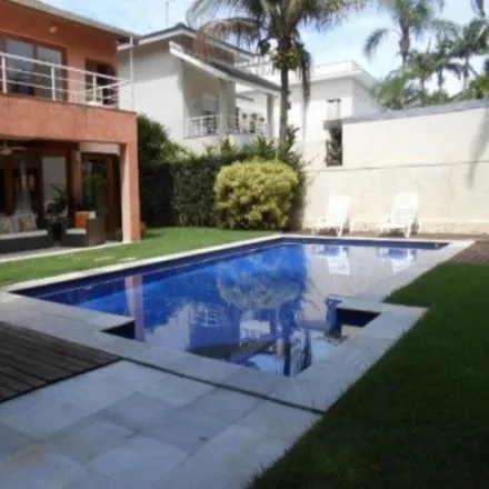 Rent this 4 bed house on Alameda Agogô in Riviera, Bertioga - SP