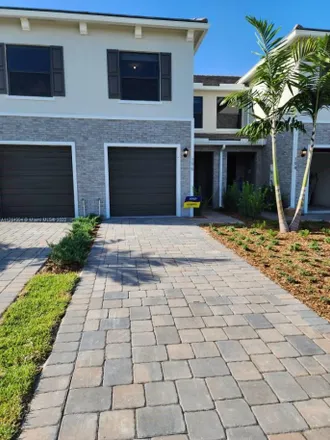 Rent this 3 bed townhouse on 196 Southeast 5th Court in Carver Heights, Deerfield Beach