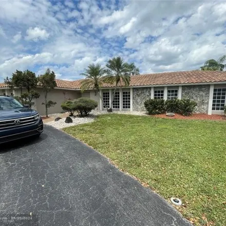 Rent this 4 bed house on The Country Club of Coral Springs in 10800 West Sample Road, Coral Springs