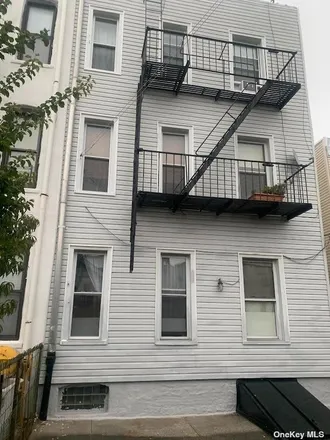 Buy this 8 bed townhouse on 74-36 64th Lane in New York, NY 11385