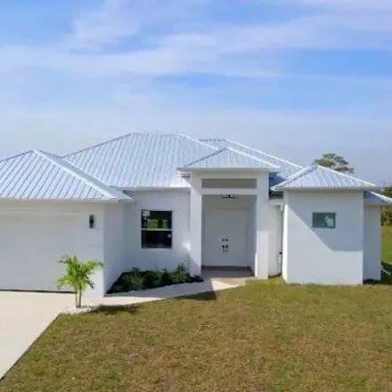 Rent this 3 bed house on 303 Ranch Avenue in Lehigh Acres, FL 33974