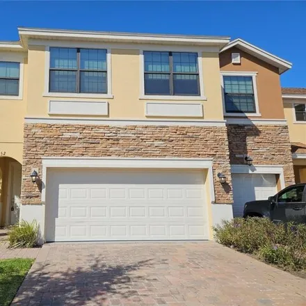 Rent this 4 bed townhouse on 1956 Portofino Meadows Boulevard in Meadow Woods, Orange County