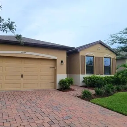 Rent this 4 bed house on 4084 Caladium Cir in West Melbourne, Florida