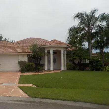 Rent this 4 bed house on 5811 NW Rose Petal Ct in Port Saint Lucie, Florida