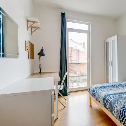 Rent this 6 bed room on Rua Carrilho Videira in 1170-347 Lisbon, Portugal