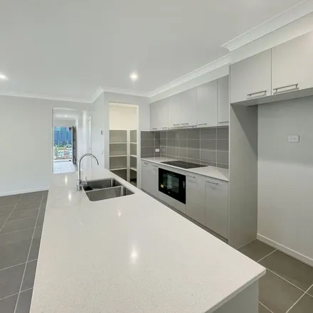 Rent this 4 bed apartment on Belvedere Drive in Spring Mountain QLD 4300, Australia