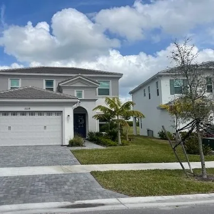 Rent this 4 bed house on 5518 Macoon Way in Loxahatchee, Florida