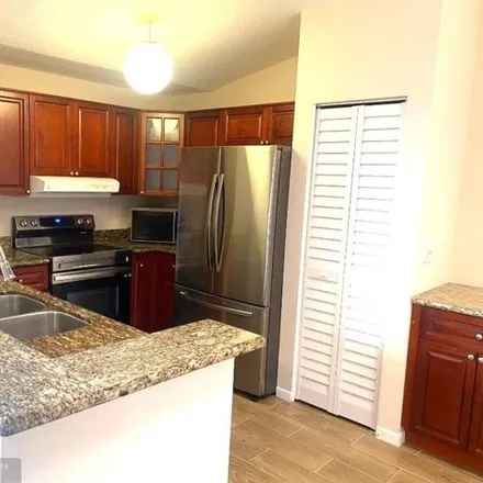 Rent this 3 bed house on The Pines West in Broward County, FL 33309