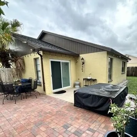 Rent this 3 bed house on 1323 Denlow Ln in Royal Palm Beach, Florida